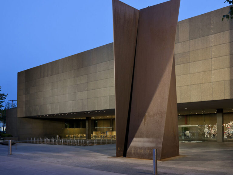 exterior of Carnegie Museum of Art with large metal structure at dusk